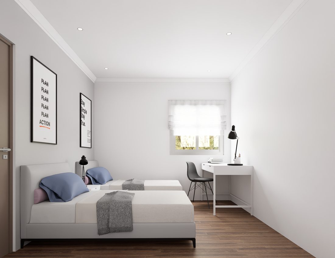Private bedroom with twin beds, study desk, and natural light